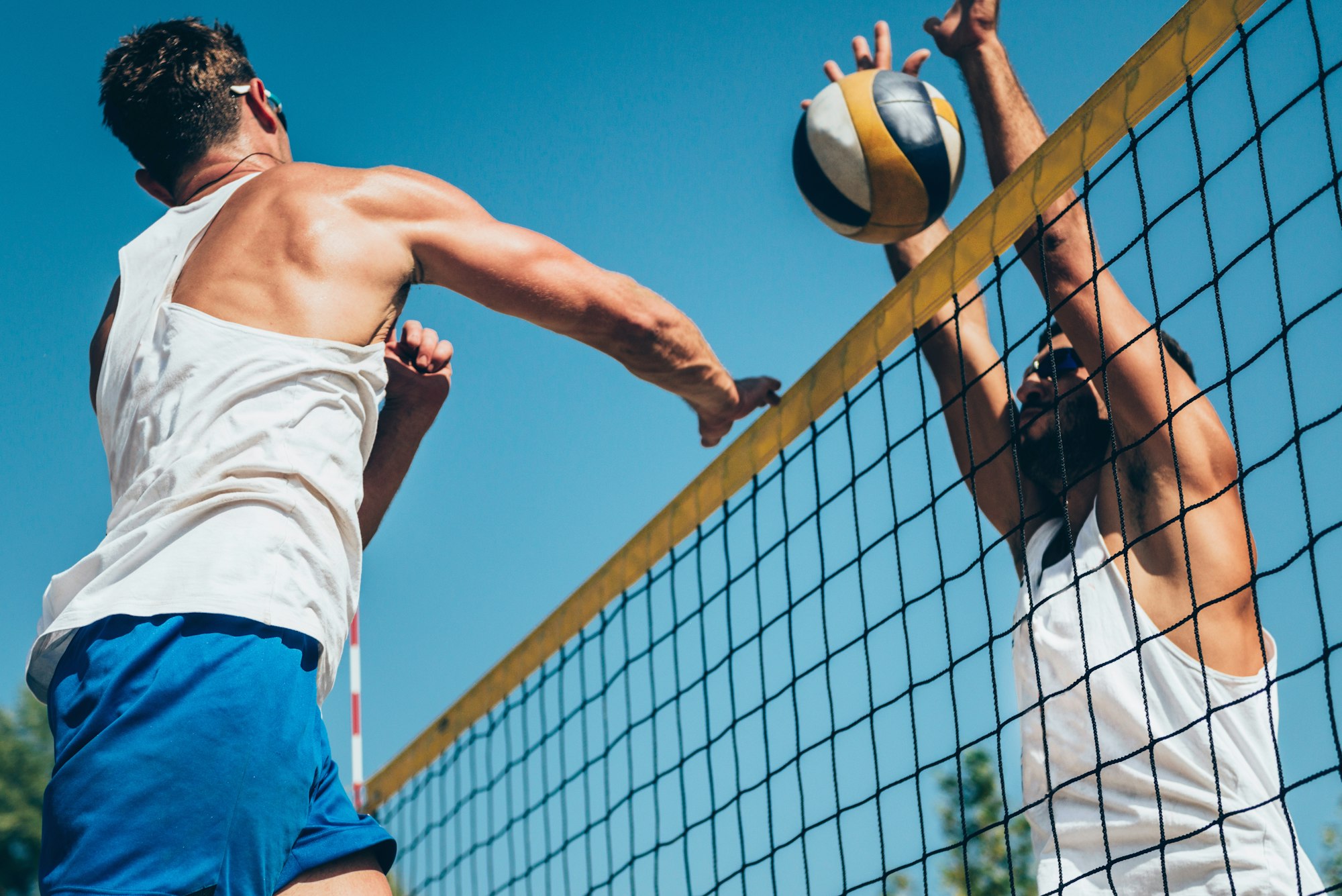 Beach volleyball detail - Males on the net